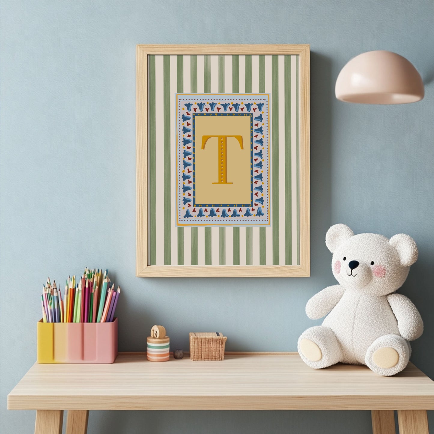 Nursery alphabet wall art featuring the letter of your choice a golden serif font with decorative block-print inspired folk floral border and a muted green striped background, perfect for baby room decor, personalized children’s wall art, alphabet nursery print, gender-neutral baby gift, Montessori room decor, educational wall art, and unique custom gift ideas for kids