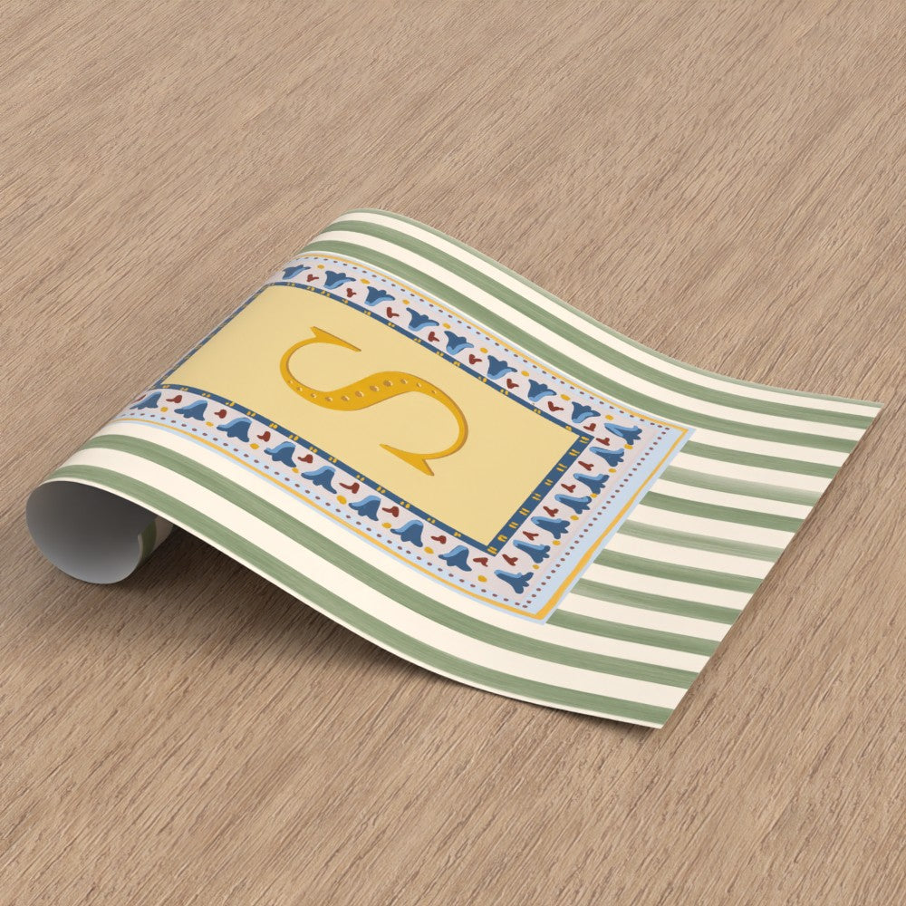 Nursery alphabet wall art featuring the letter of your choice a golden serif font with decorative block-print inspired folk floral border and a muted green striped background, perfect for baby room decor, personalized children’s wall art, alphabet nursery print, gender-neutral baby gift, Montessori room decor, educational wall art, and unique custom gift ideas for kids