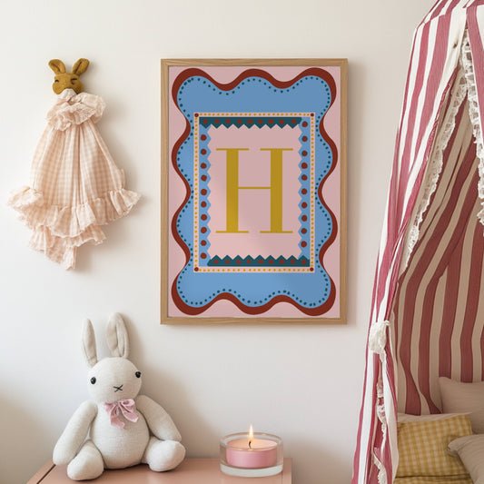 Playful alphabet wall art featuring the letter ‘H’ in a bold gold font, set against a pink and blue patterned background with wavy borders—perfect as a decorative nursery or children’s bedroom/playroom print and a charming, unique gift idea for adults and kids alike. 